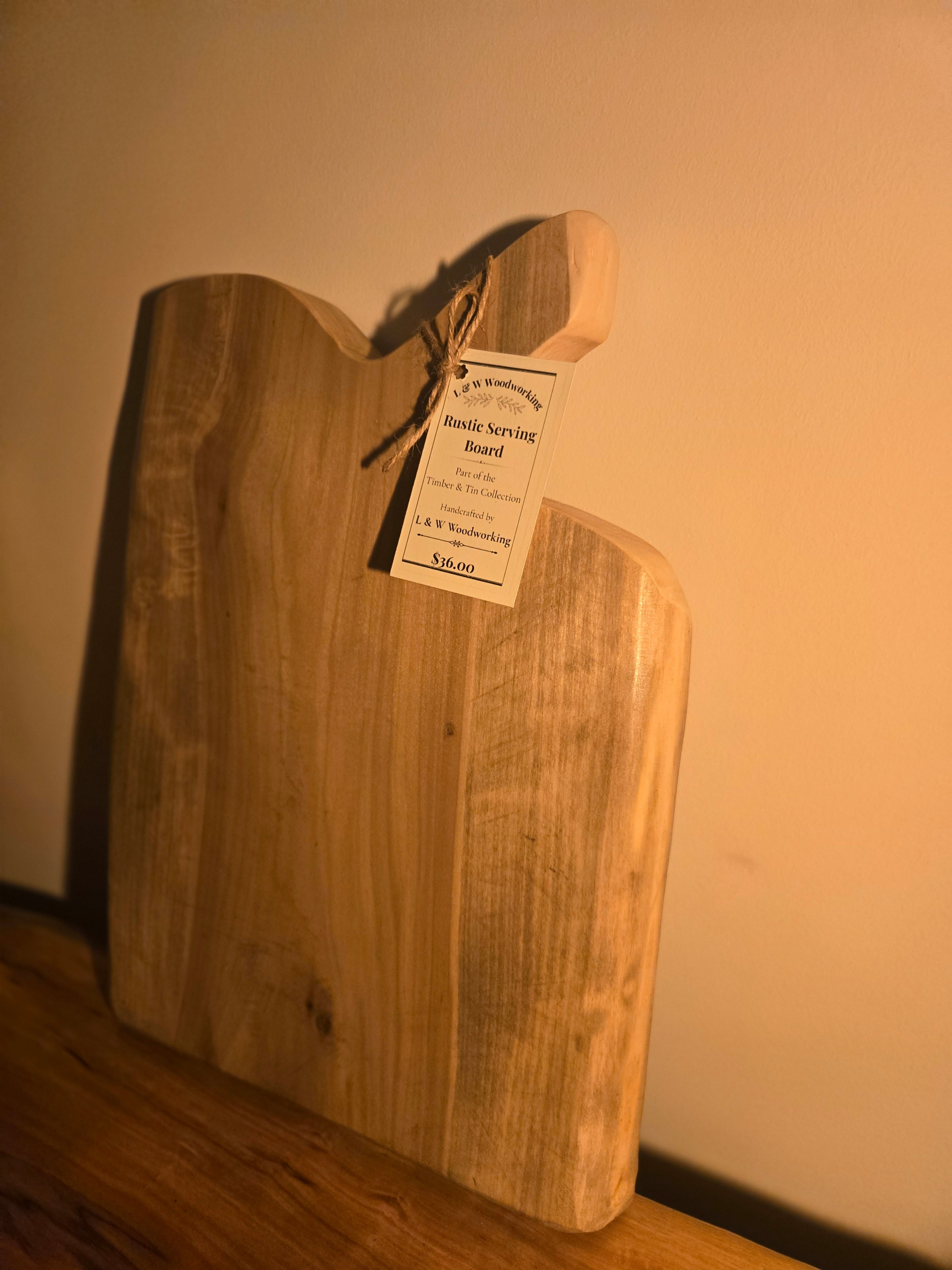 Serving board cut from a live edge slab and stained with coffee. Butcher block oil and beeswax have been added to seal and protect. 